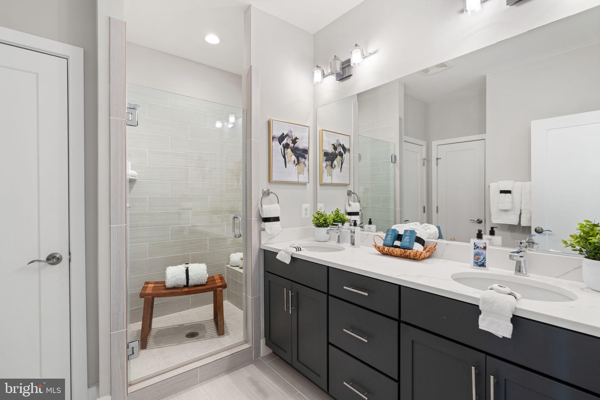 3006 Eskridge Road Fairfax, VA 22031 - Photo 17 of 41 a bathroom with a sink double vanity granite tub shower and a mirror