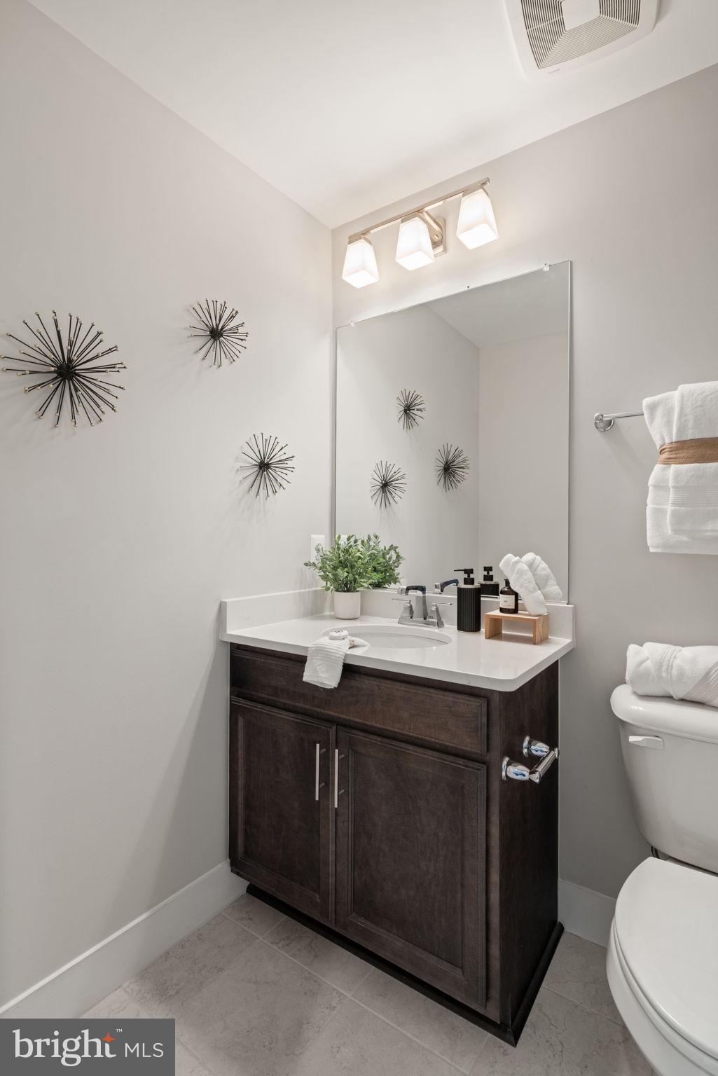 3006 Eskridge Road Fairfax, VA 22031 - Photo 20 of 41 a bathroom with a toilet sink and mirror