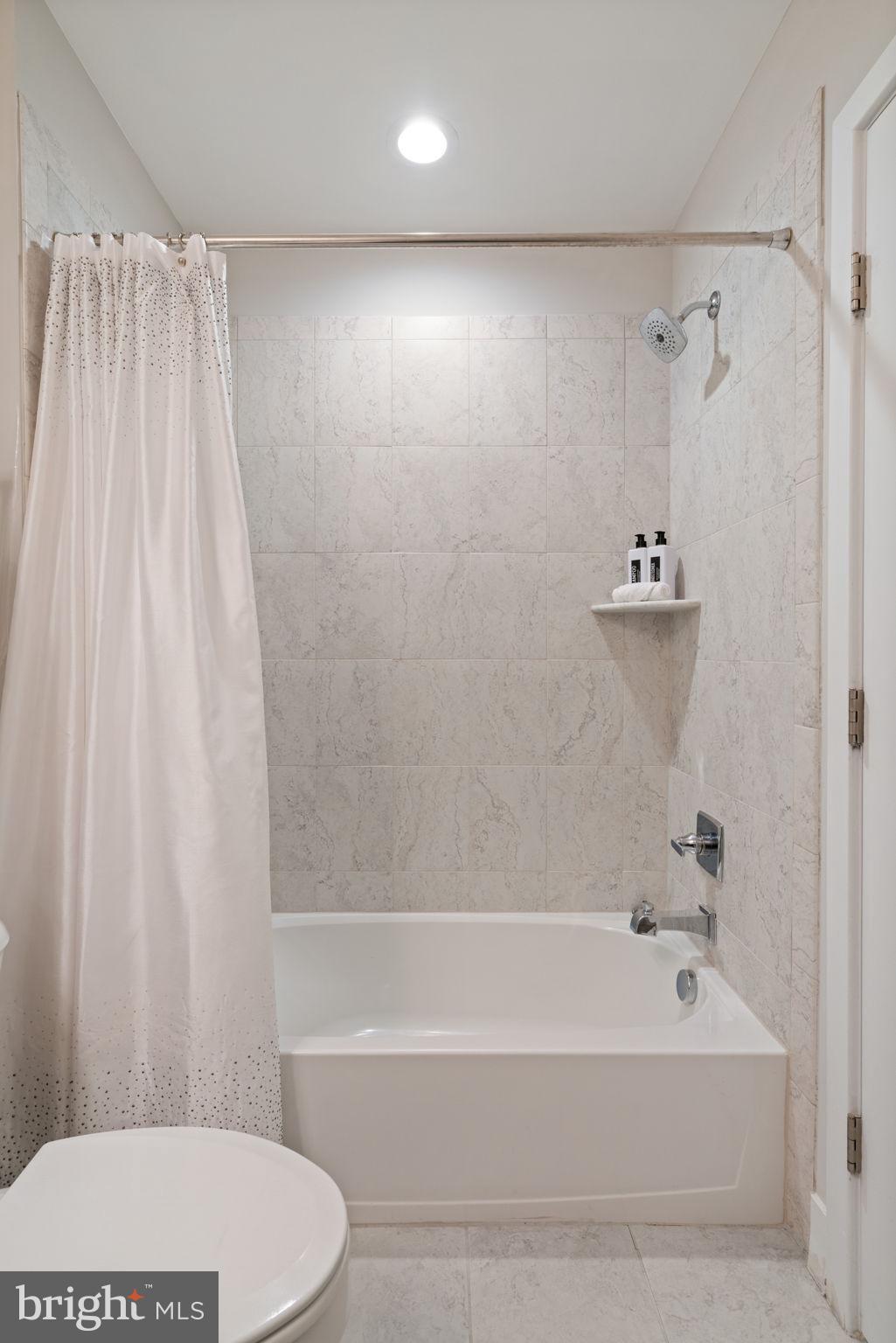 3006 Eskridge Road Fairfax, VA 22031 - Photo 21 of 41 a bathroom with a bathtub and shower