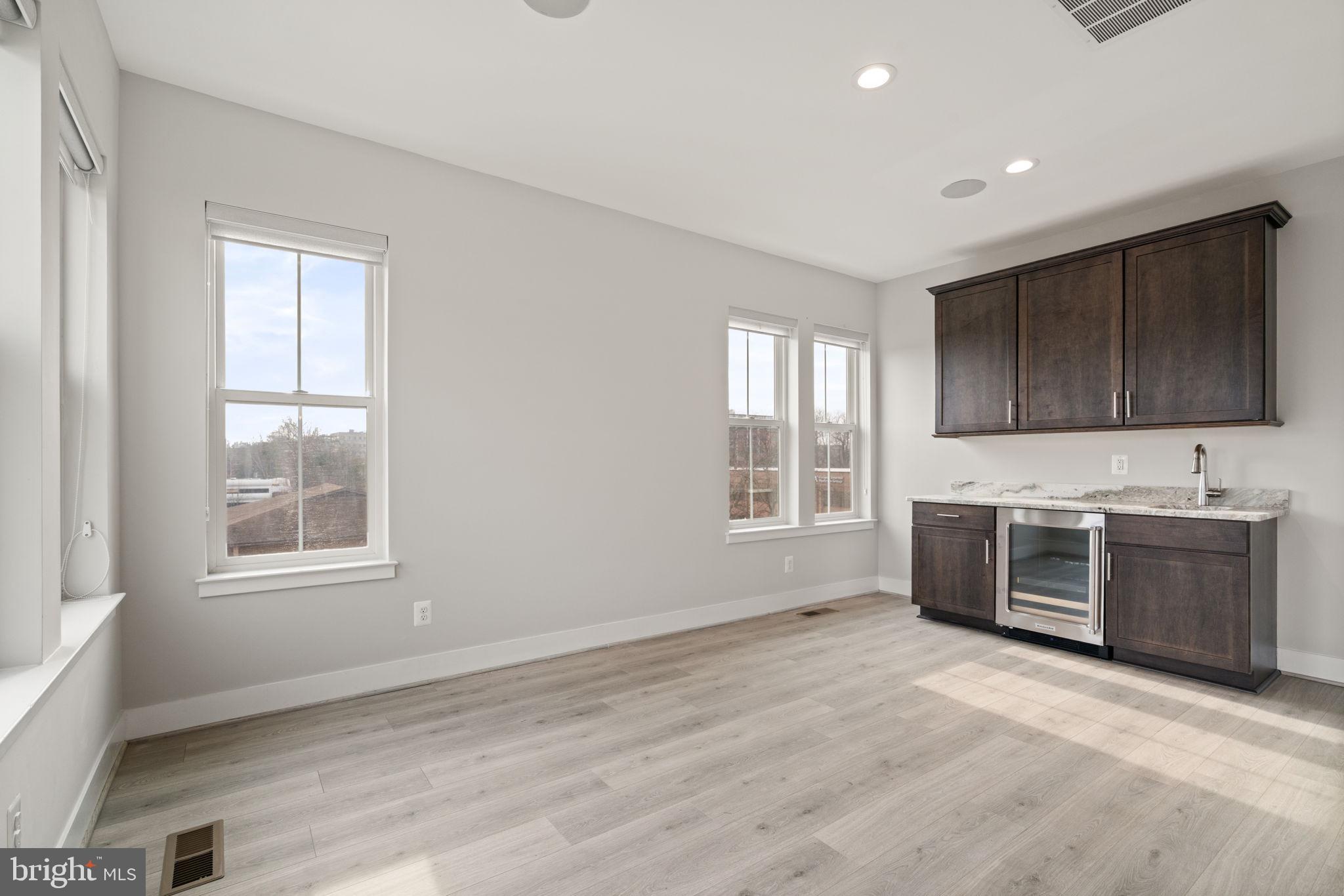 3006 Eskridge Road Fairfax, VA 22031 - Photo 23 of 41 a large kitchen with stainless steel appliances granite countertop a stove a sink and a microwave
