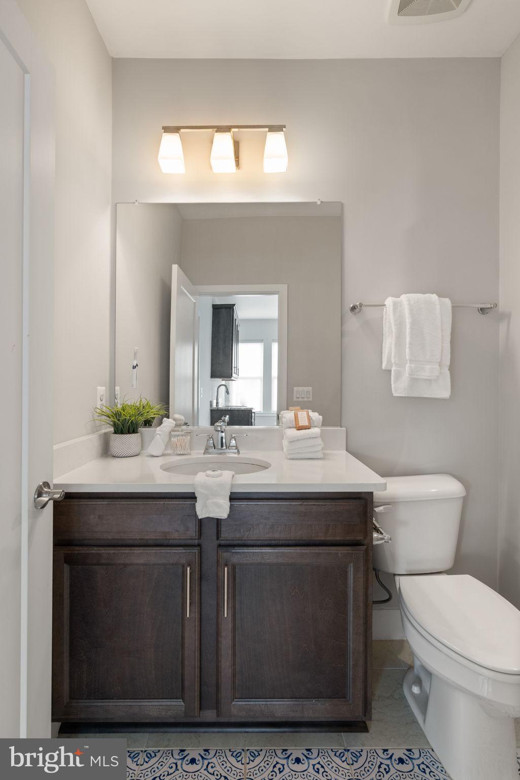 3006 Eskridge Road Fairfax, VA 22031 - Photo 26 of 41 a bathroom with a toilet a sink and mirror