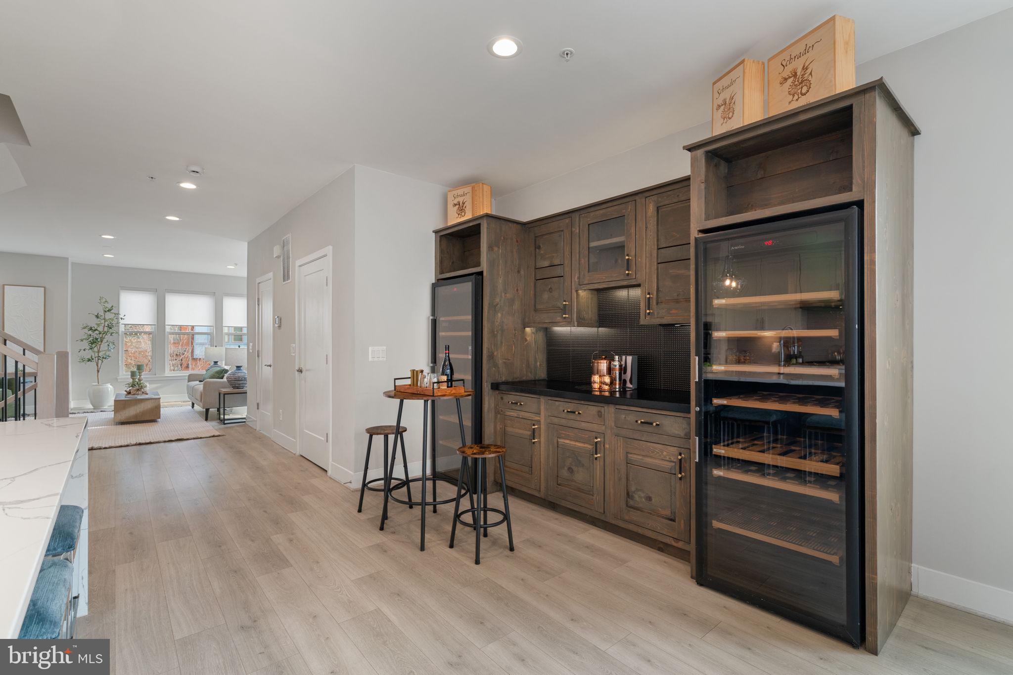 3006 Eskridge Road Fairfax, VA 22031 - Photo 34 of 41 a kitchen with a refrigerator a stove and a dining table with wooden floor