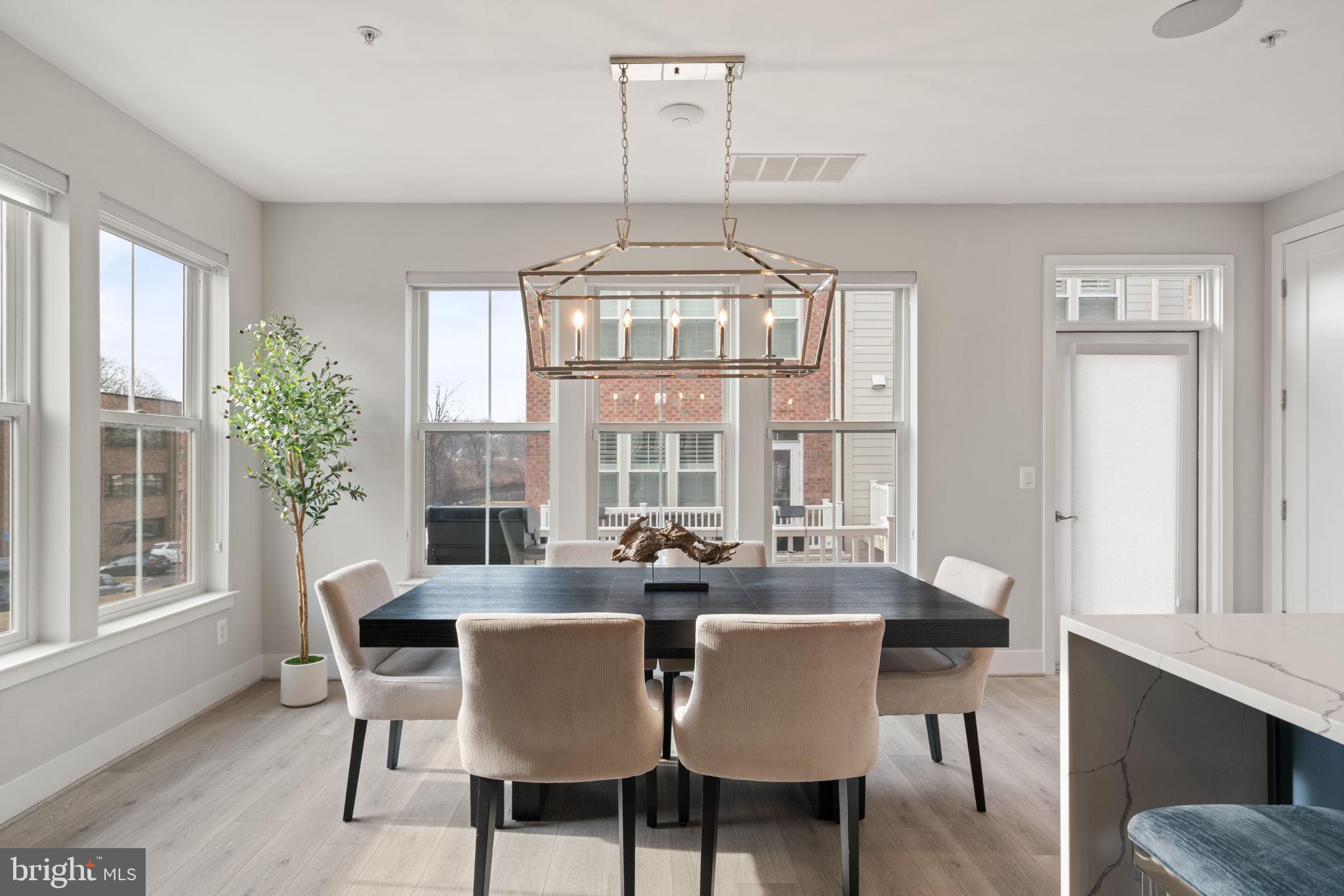 3006 Eskridge Road Fairfax, VA 22031 - Photo 9 of 41 a dining room with furniture a chandelier and wooden floor