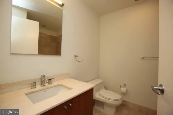 a bathroom with a sink mirror and toilet