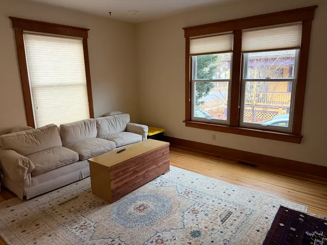 a kitchen with a sink appliances cabinets and a window