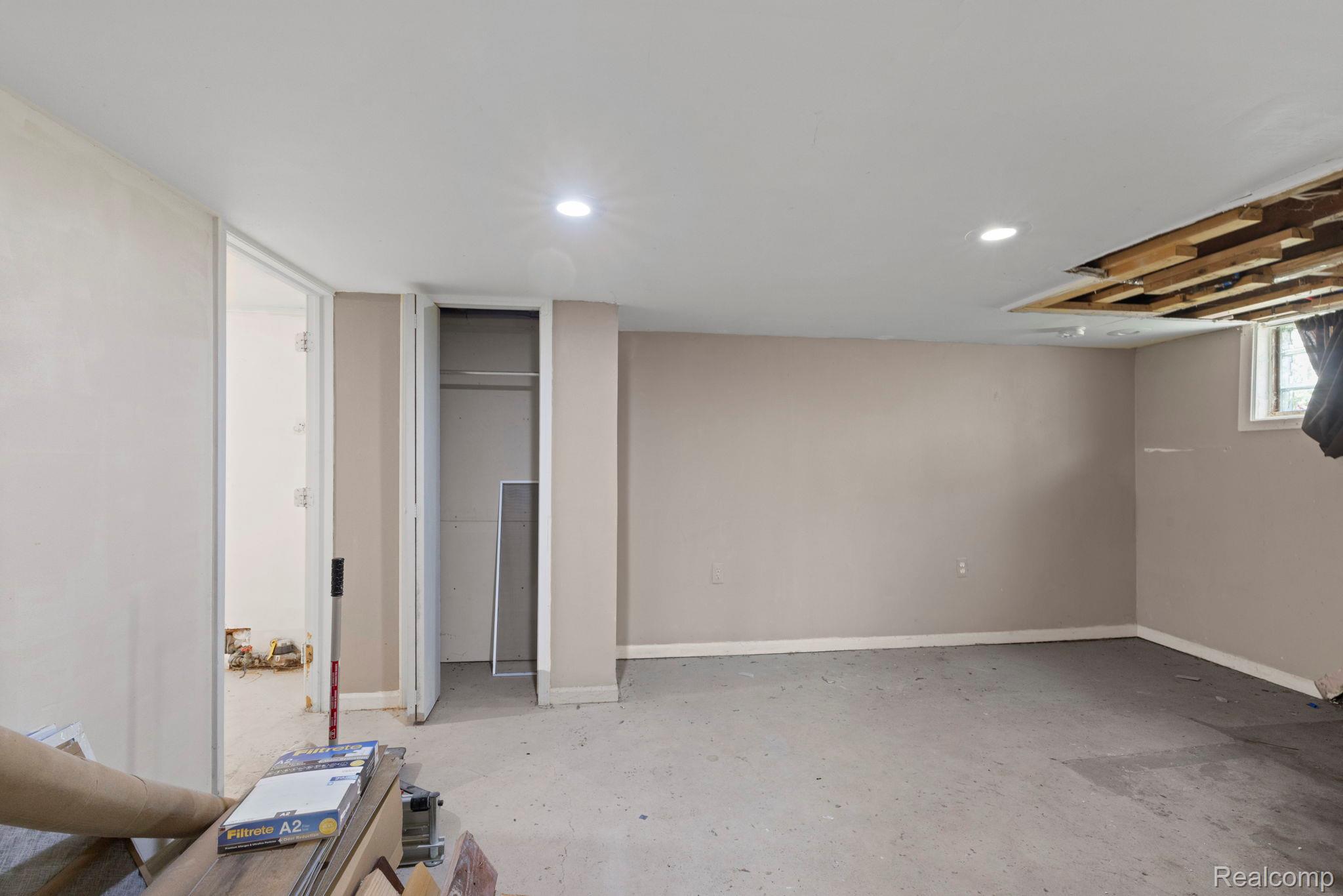 2891 Culbertson Avenue Rochester, MI 48307 - Photo 21 of 27 Spacious room featuring light gray painted walls, recessed ceiling lighting, and a window