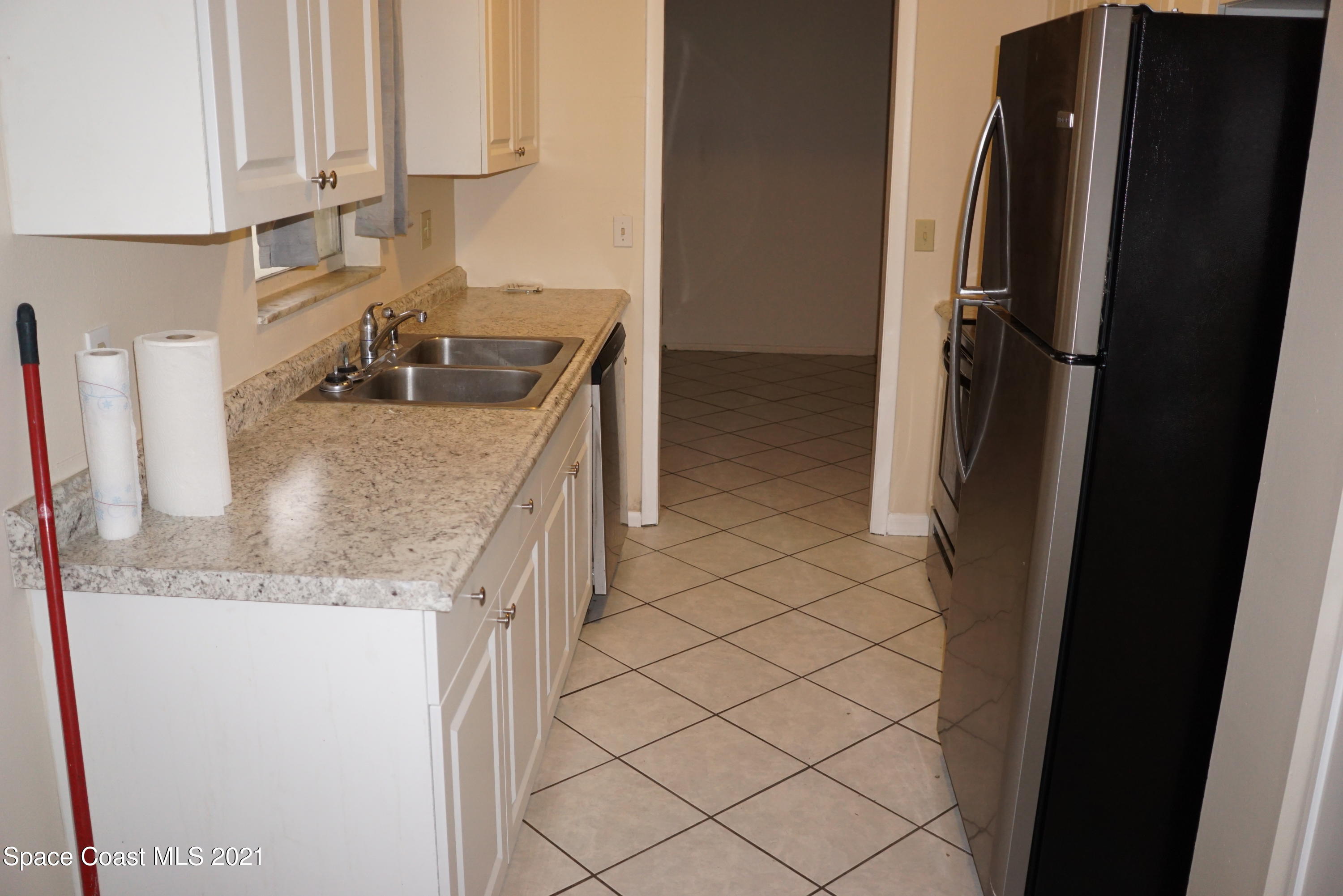 1052 Bernice Road Rockledge, FL 32955 - Photo 14 of 39 a kitchen with stainless steel appliances granite countertop a refrigerator and a sink