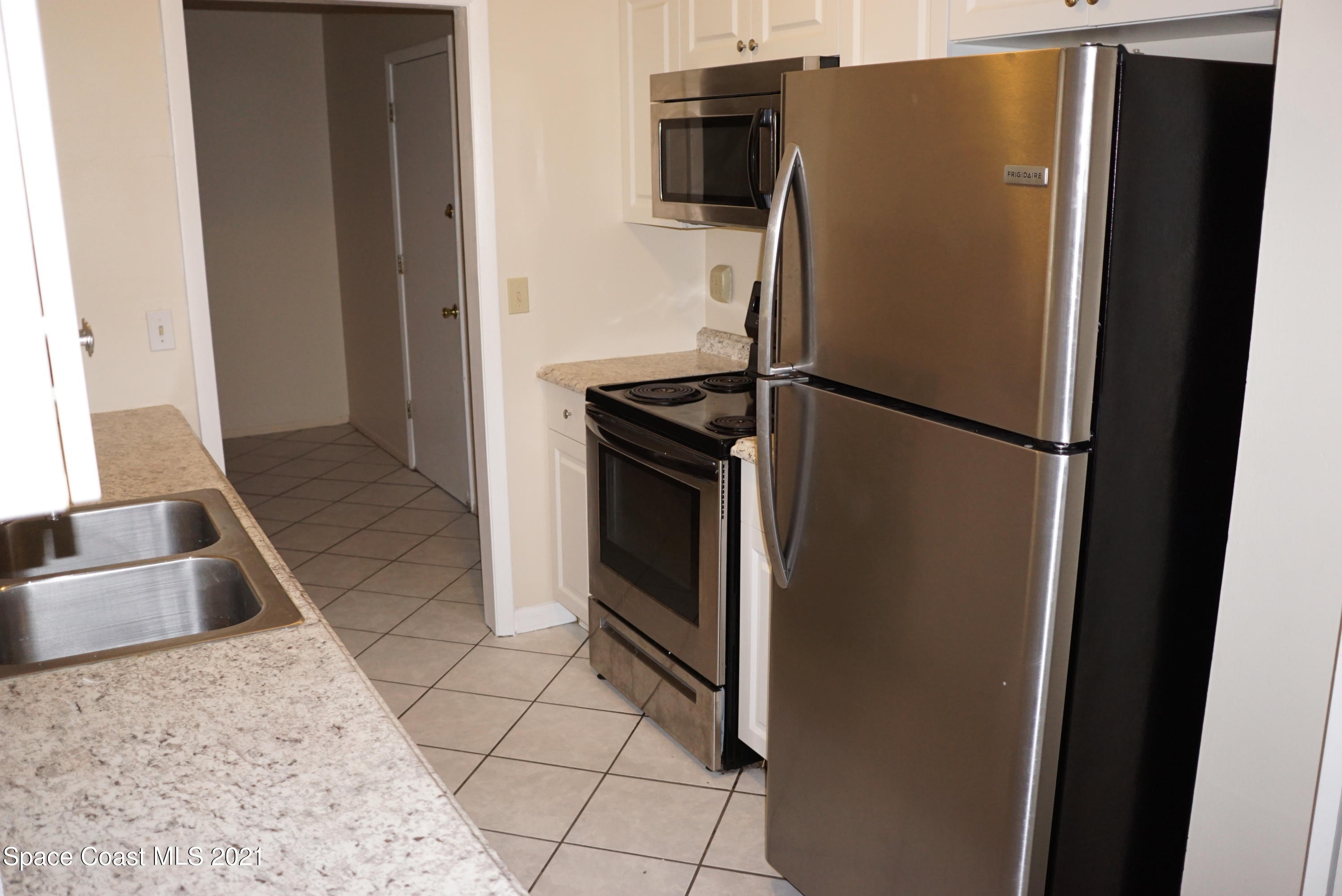 1052 Bernice Road Rockledge, FL 32955 - Photo 15 of 39 a metallic refrigerator freezer sitting in a kitchen