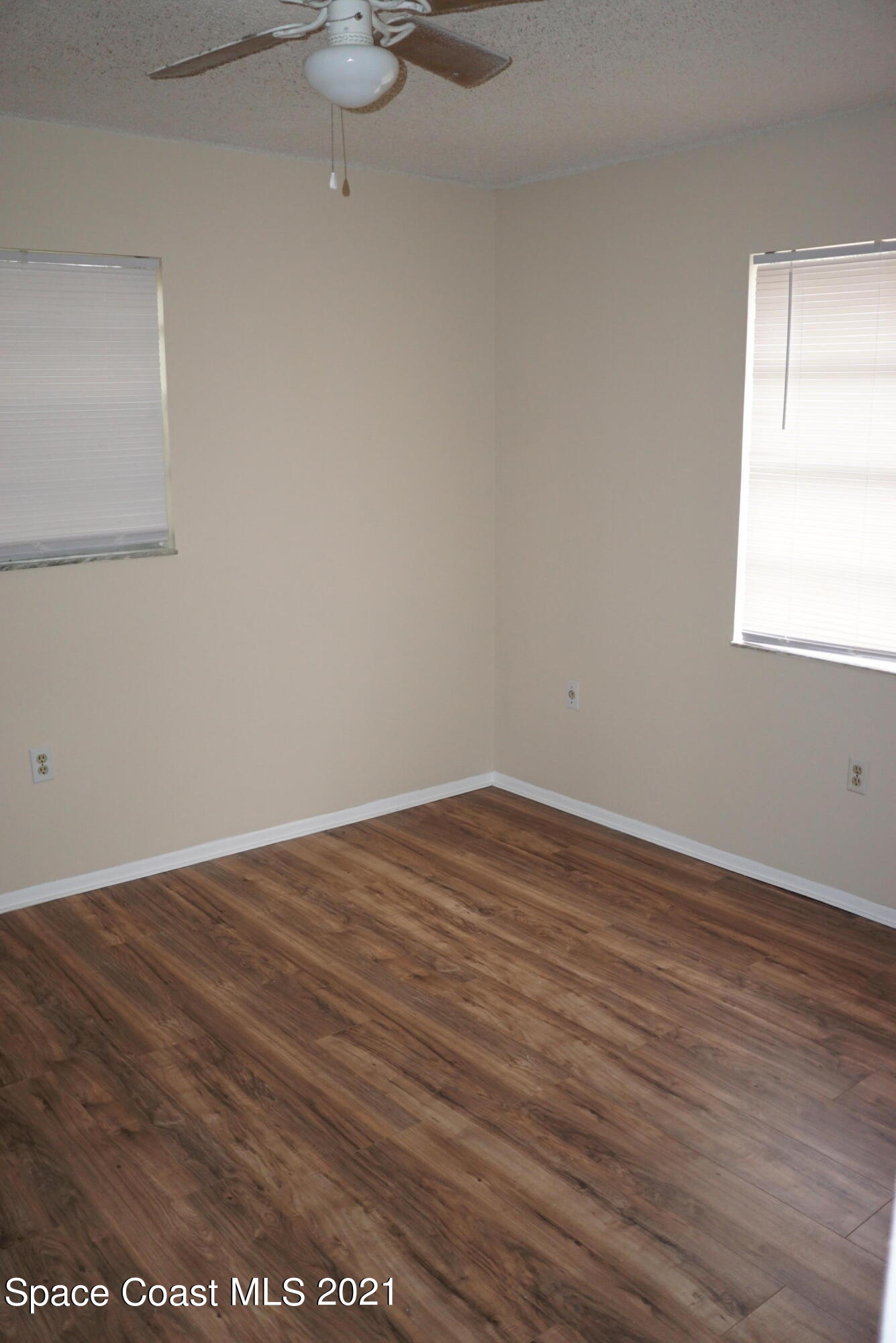 1052 Bernice Road Rockledge, FL 32955 - Photo 24 of 39 a view of an empty room with wooden floor and a window