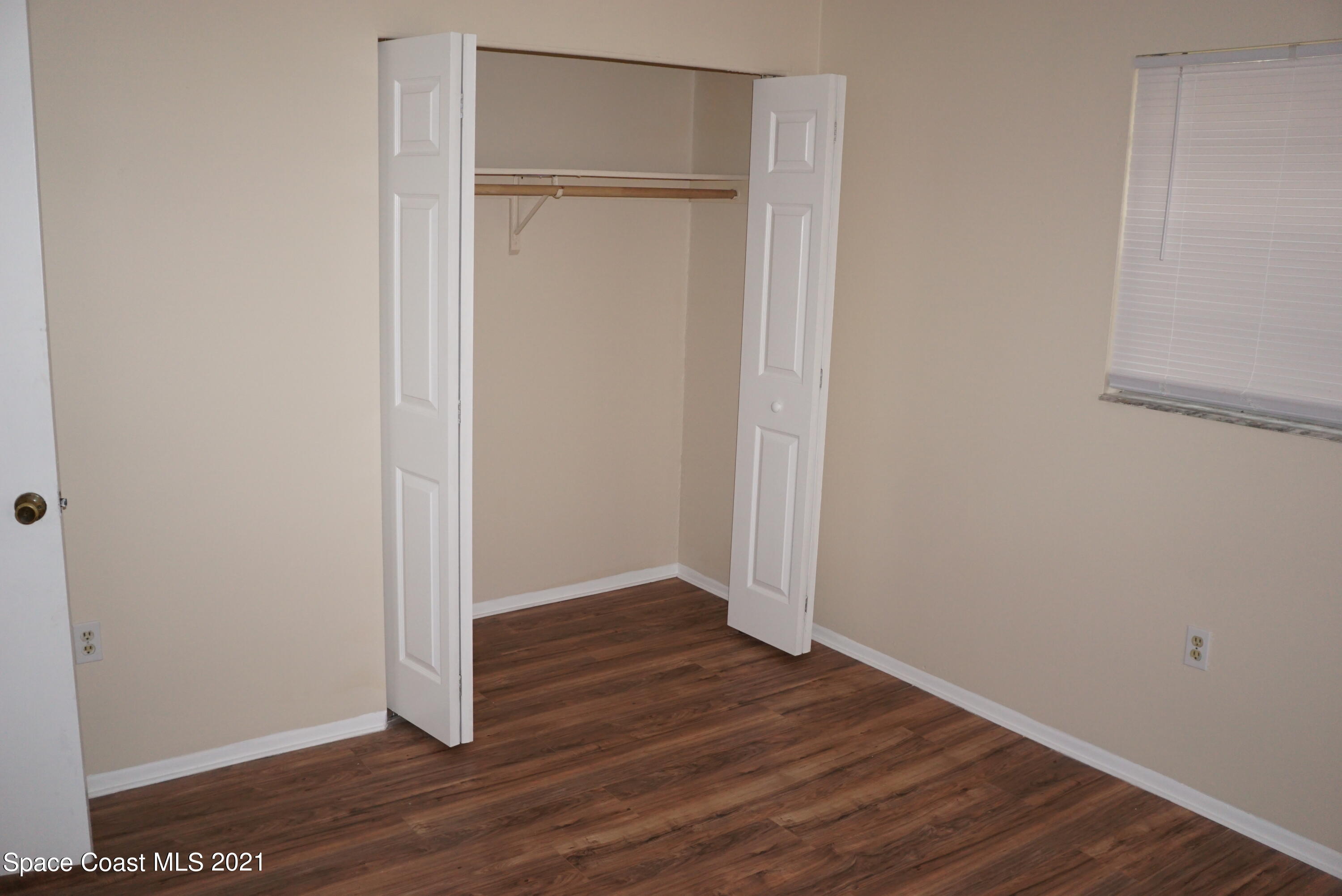 1052 Bernice Road Rockledge, FL 32955 - Photo 25 of 39 a view of an empty room with wooden floor