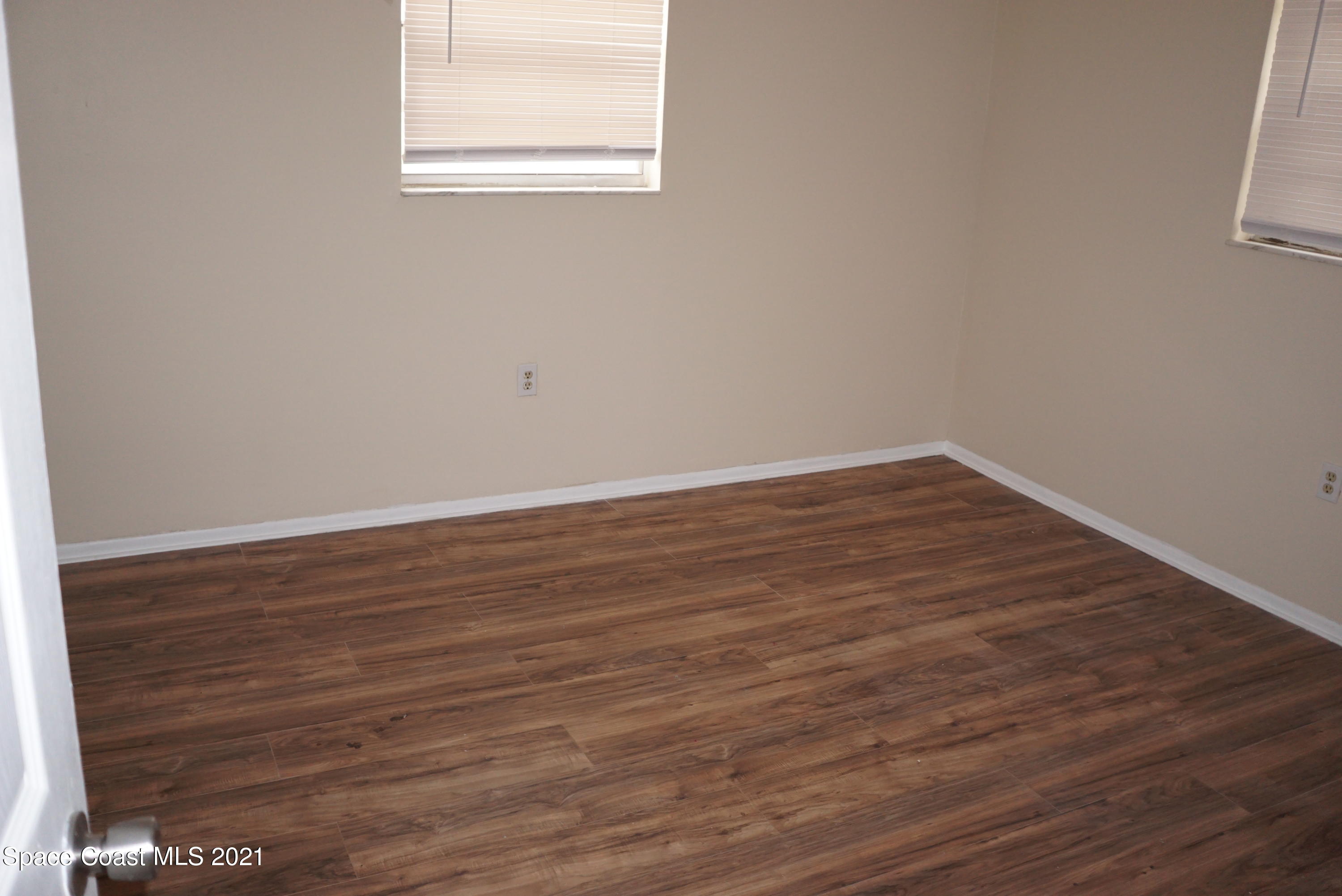 1052 Bernice Road Rockledge, FL 32955 - Photo 26 of 39 a view of an empty room with wooden floor and a window