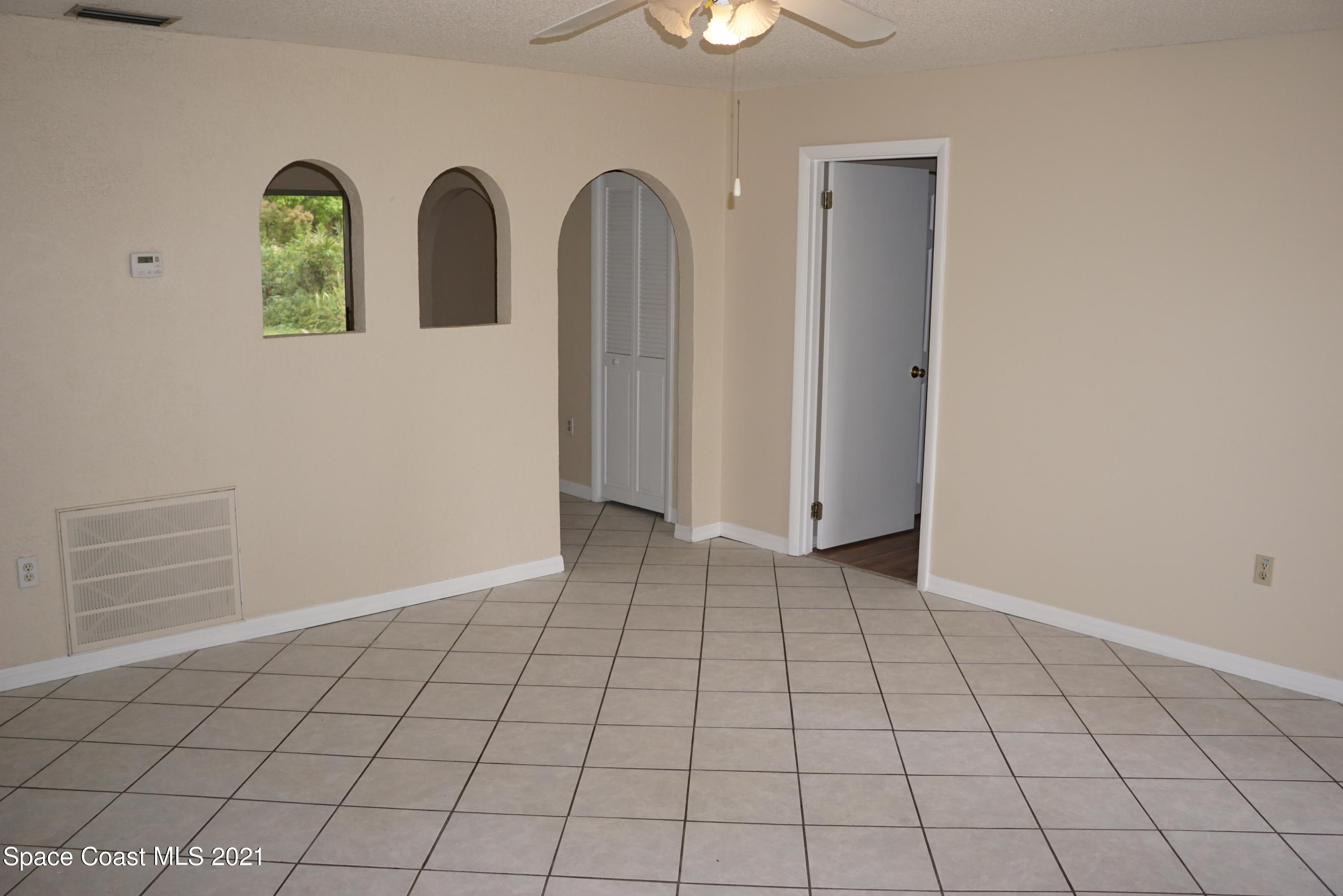 1052 Bernice Road Rockledge, FL 32955 - Photo 5 of 39 an empty room with windows