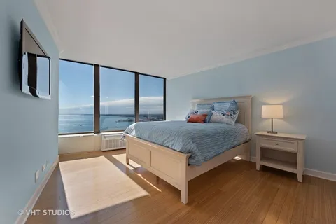 a bedroom with a large bed and a large window