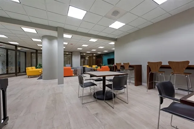 a living room with furniture a table tennis and a flat screen tv