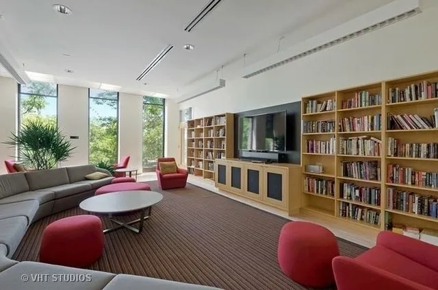 a living room with furniture and a book shelf