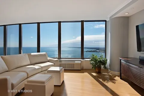 a living room with furniture and large windows