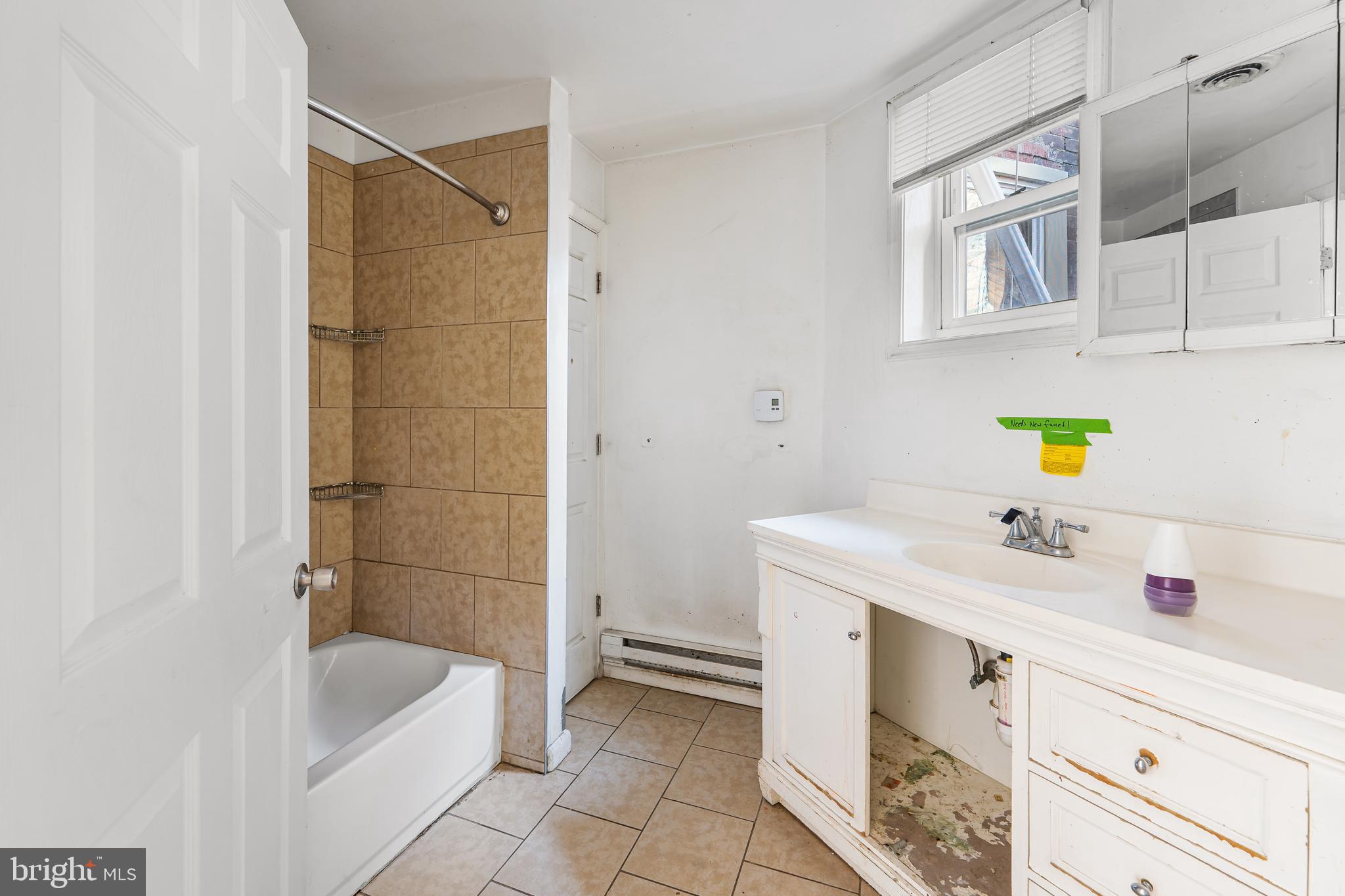 5215 Chester Avenue Philadelphia, PA 19143 - Photo 8 of 19 a bathroom with a sink vanity tub and shower