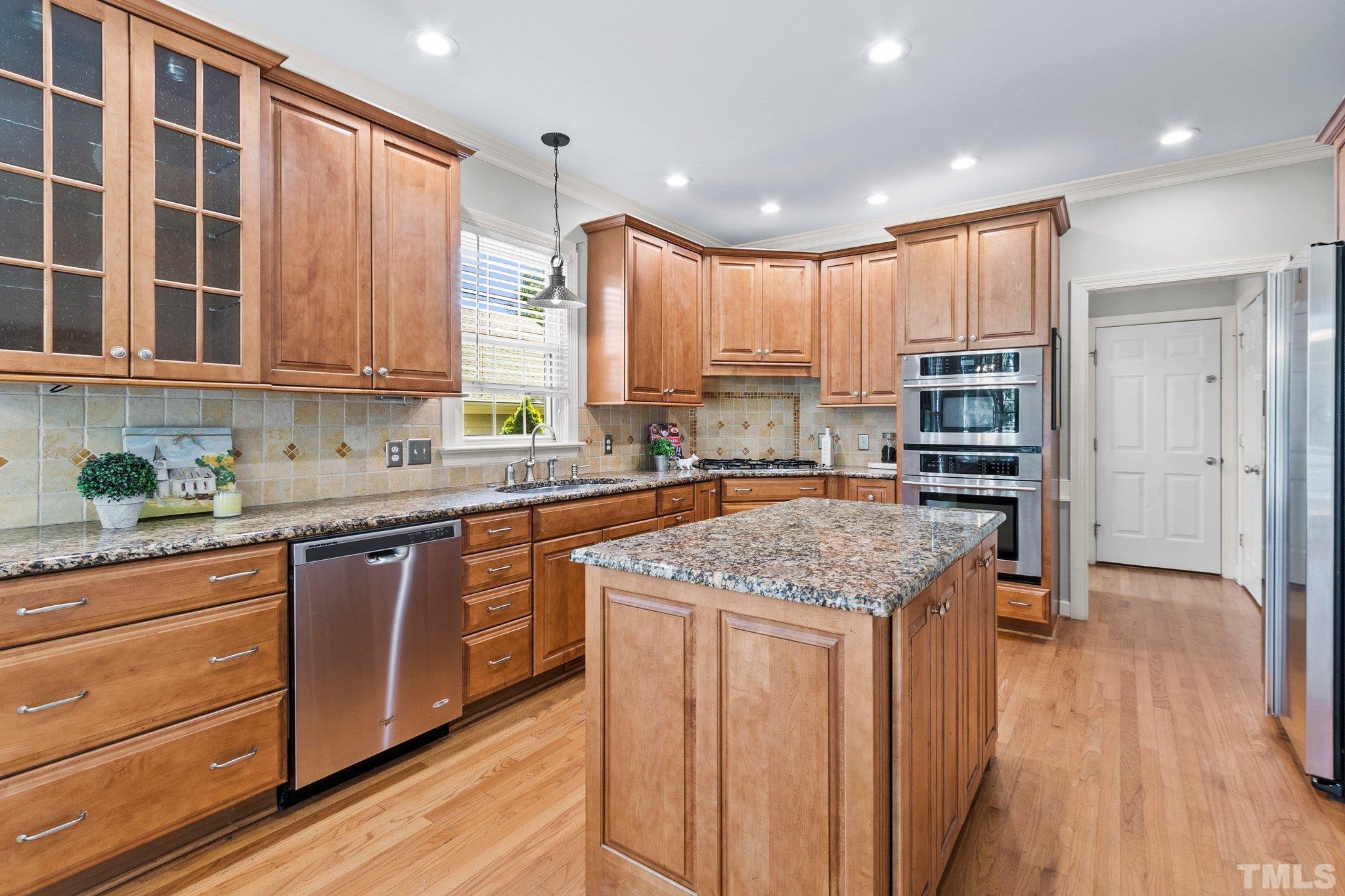 269 Hogans Valley Way Cary, NC 27513 - Photo 12 of 42 a kitchen with stainless steel appliances granite countertop a stove a sink and a refrigerator