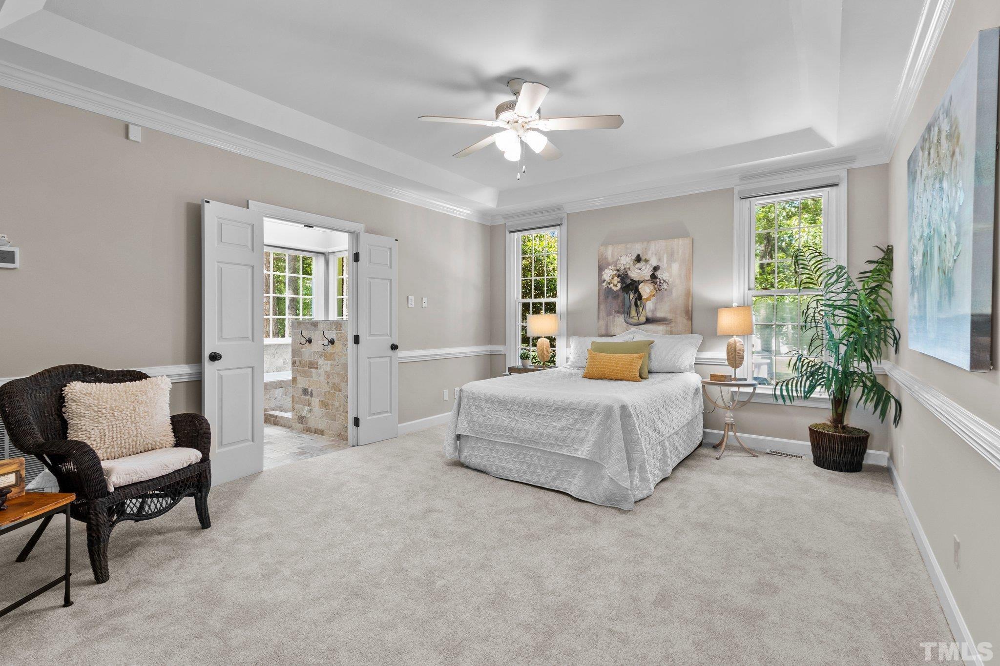 269 Hogans Valley Way Cary, NC 27513 - Photo 16 of 42 a bedroom with a large bed and a chandelier