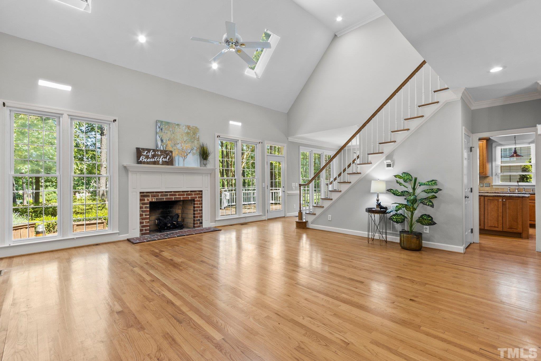 269 Hogans Valley Way Cary, NC 27513 - Photo 5 of 42 a view of an empty room with wooden floor fireplace and a window