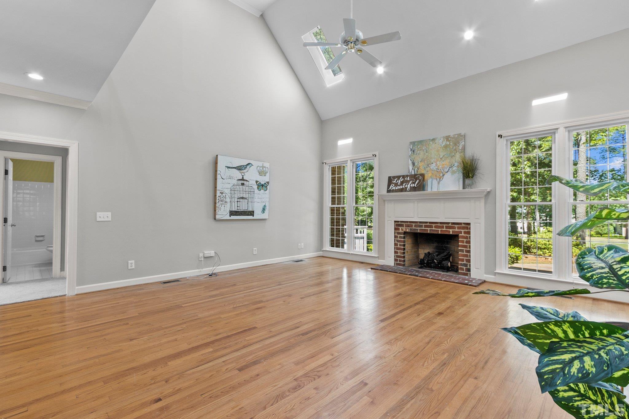 269 Hogans Valley Way Cary, NC 27513 - Photo 7 of 42 a view of empty room with wooden floor and a fireplace