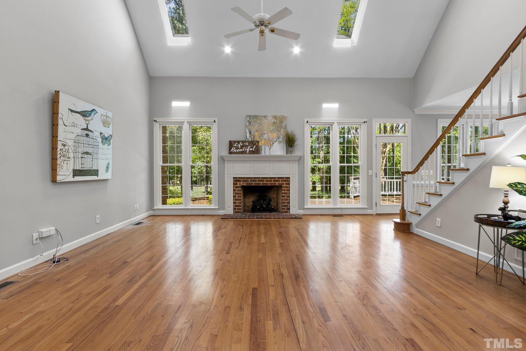 269 Hogans Valley Way Cary, NC 27513 - Photo 8 of 42 a view of an empty room with wooden floor fireplace and a window