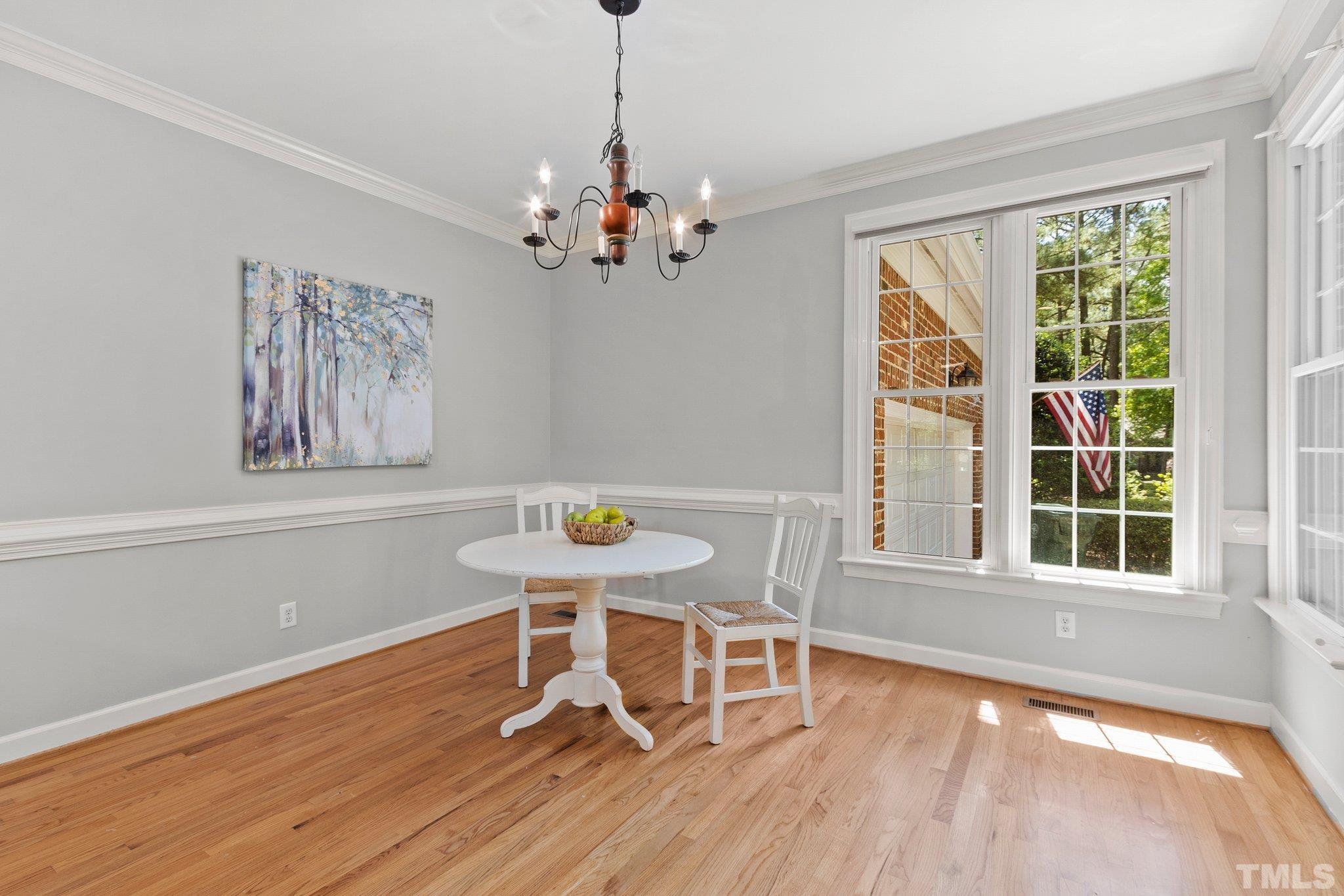 269 Hogans Valley Way Cary, NC 27513 - Photo 9 of 42 a view of a dining room with furniture window and wooden floor