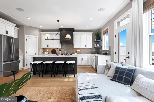 a living room with furniture a fireplace and a large window