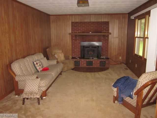 9268 Park Springs Road Ruffin, NC 27326 - Photo 11 of 16 Living Room. LIVINGROOM WITH FIREPLACE AND WOODSTOVE INSERT