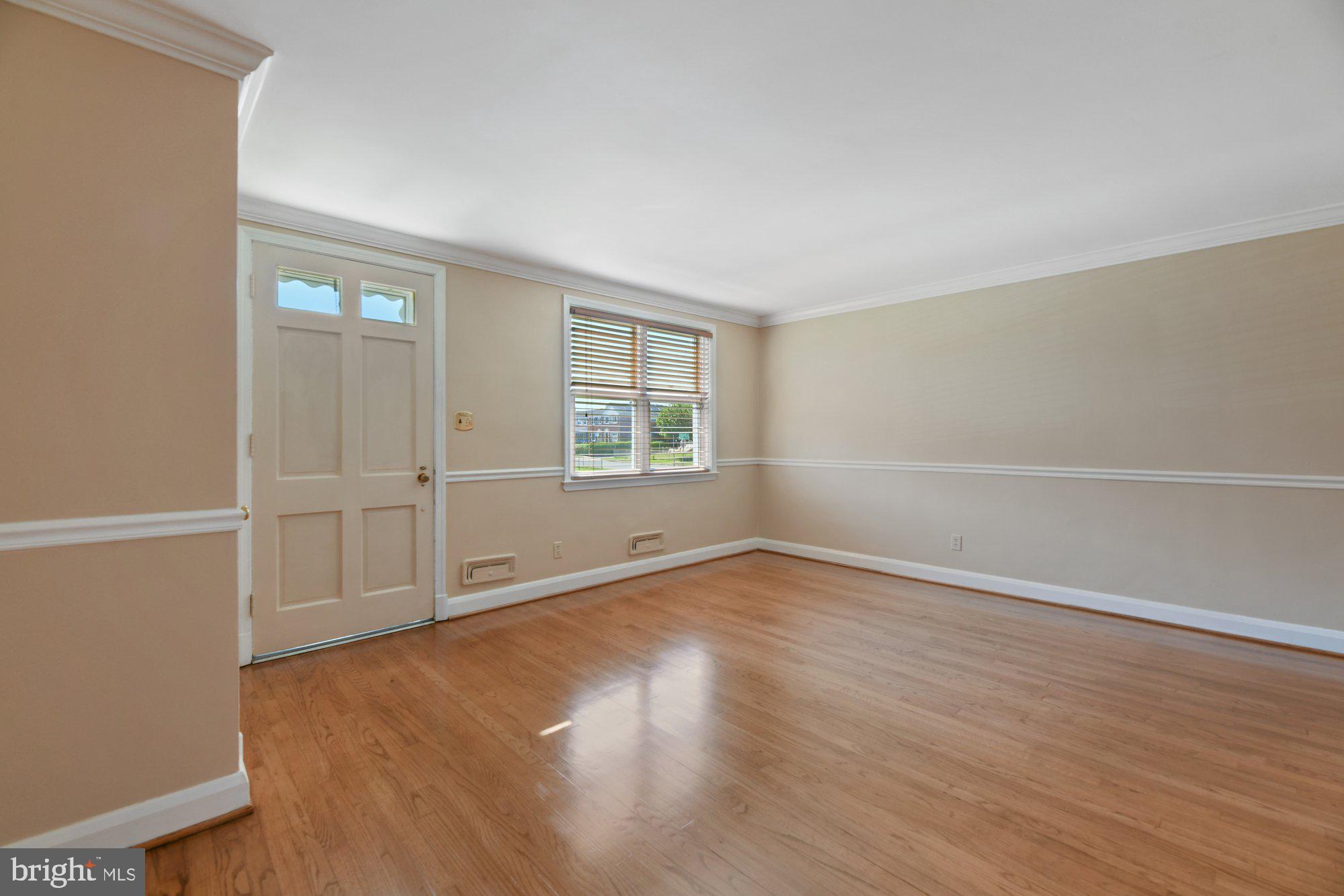 1916 Church Road Baltimore, MD 21222 - Photo 4 of 34 an empty room with wooden floor and windows