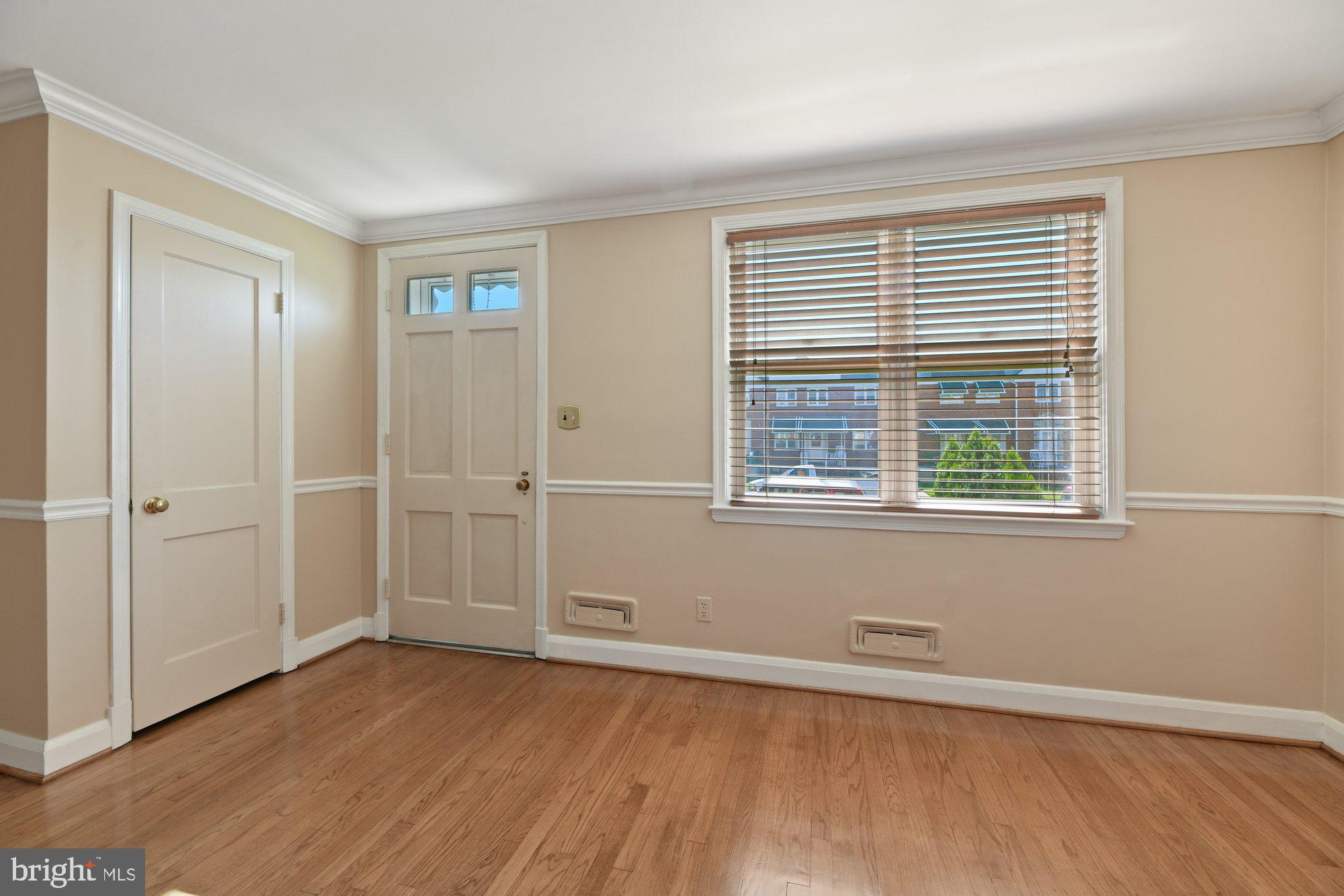 1916 Church Road Baltimore, MD 21222 - Photo 5 of 34 a view of an empty room with wooden floor and a window