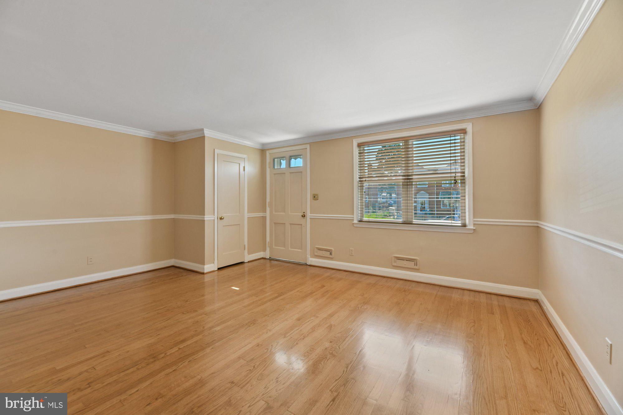 1916 Church Road Baltimore, MD 21222 - Photo 6 of 34 an empty room with wooden floor and windows