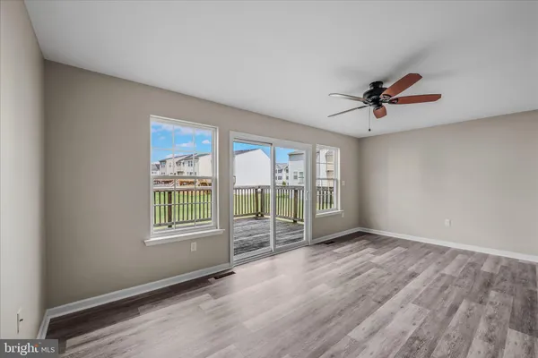 an empty room with a empty space and a ceiling fan