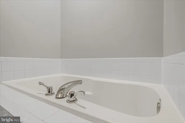 an empty room with windows and ceiling fan