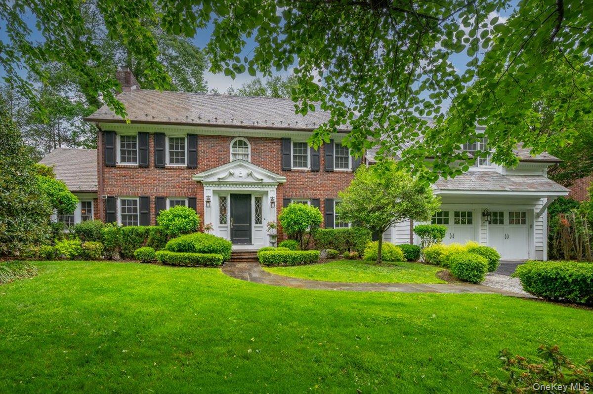 7 Harcourt Road Scarsdale, NY 10583 - Photo 1 of 34 a aerial view of a house with a yard table and chairs