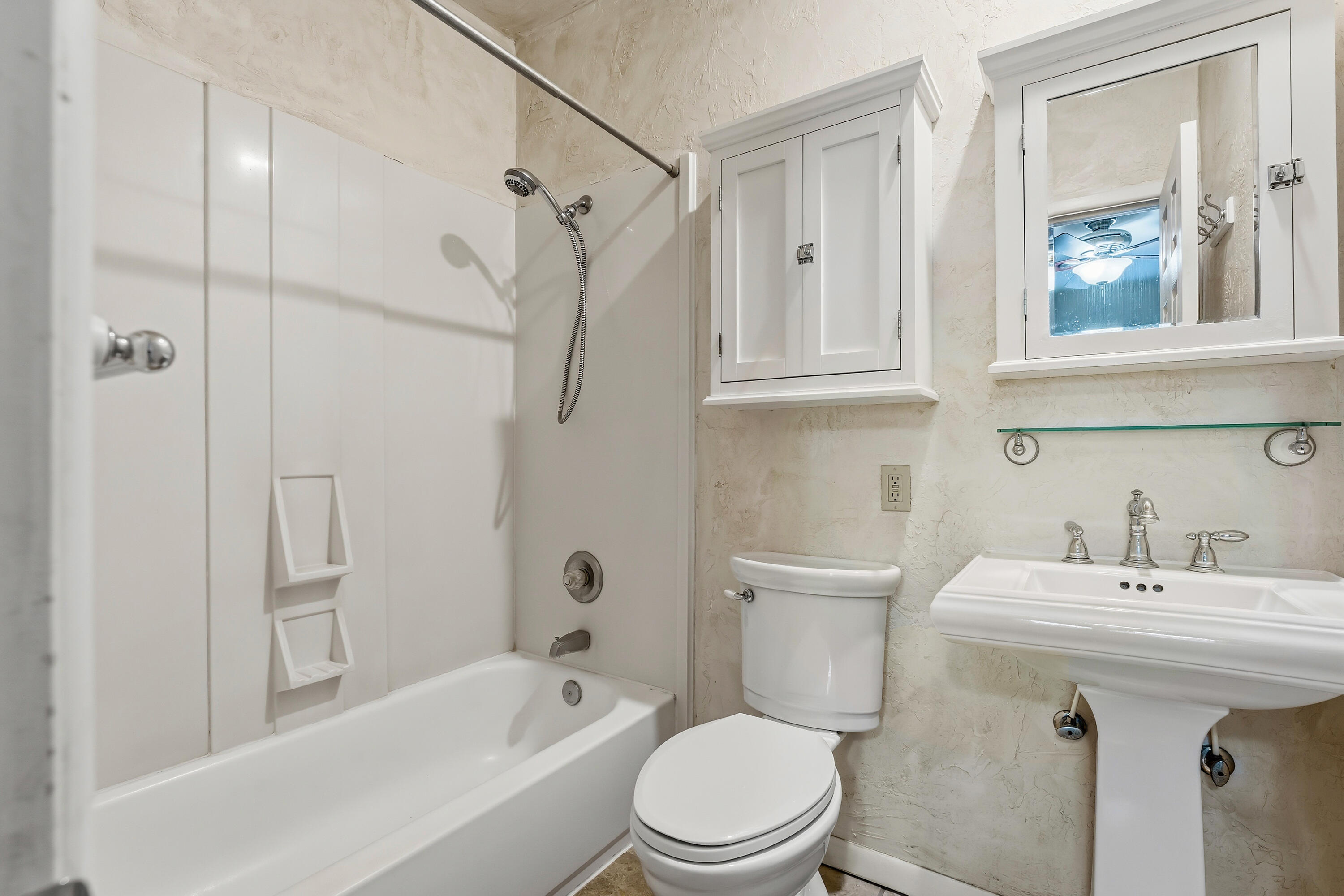 4831 10th Street Lubbock, TX 79416 - Photo 15 of 25 a bathroom with a sink a toilet and shower