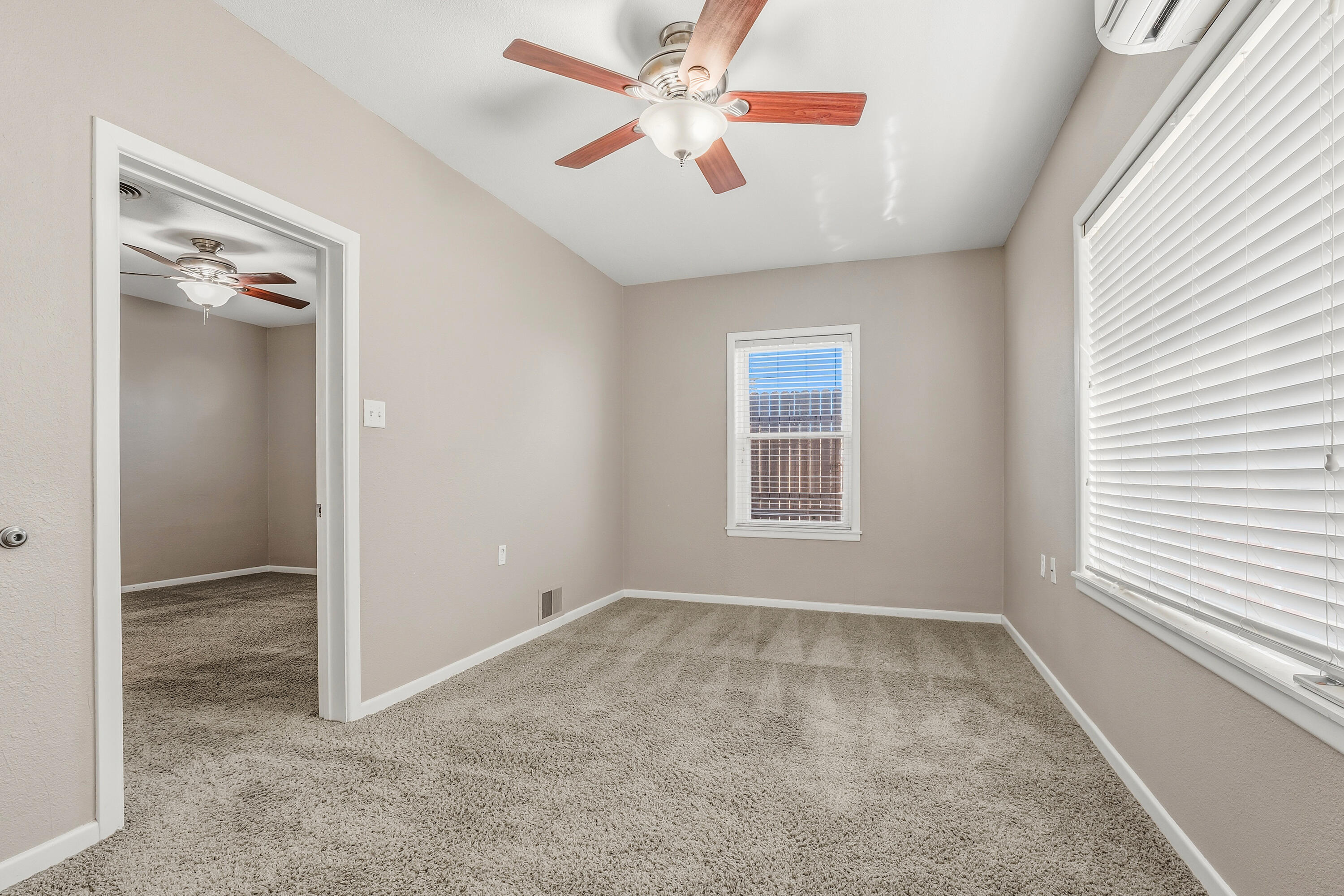 4831 10th Street Lubbock, TX 79416 - Photo 16 of 25 an empty room with windows and fan