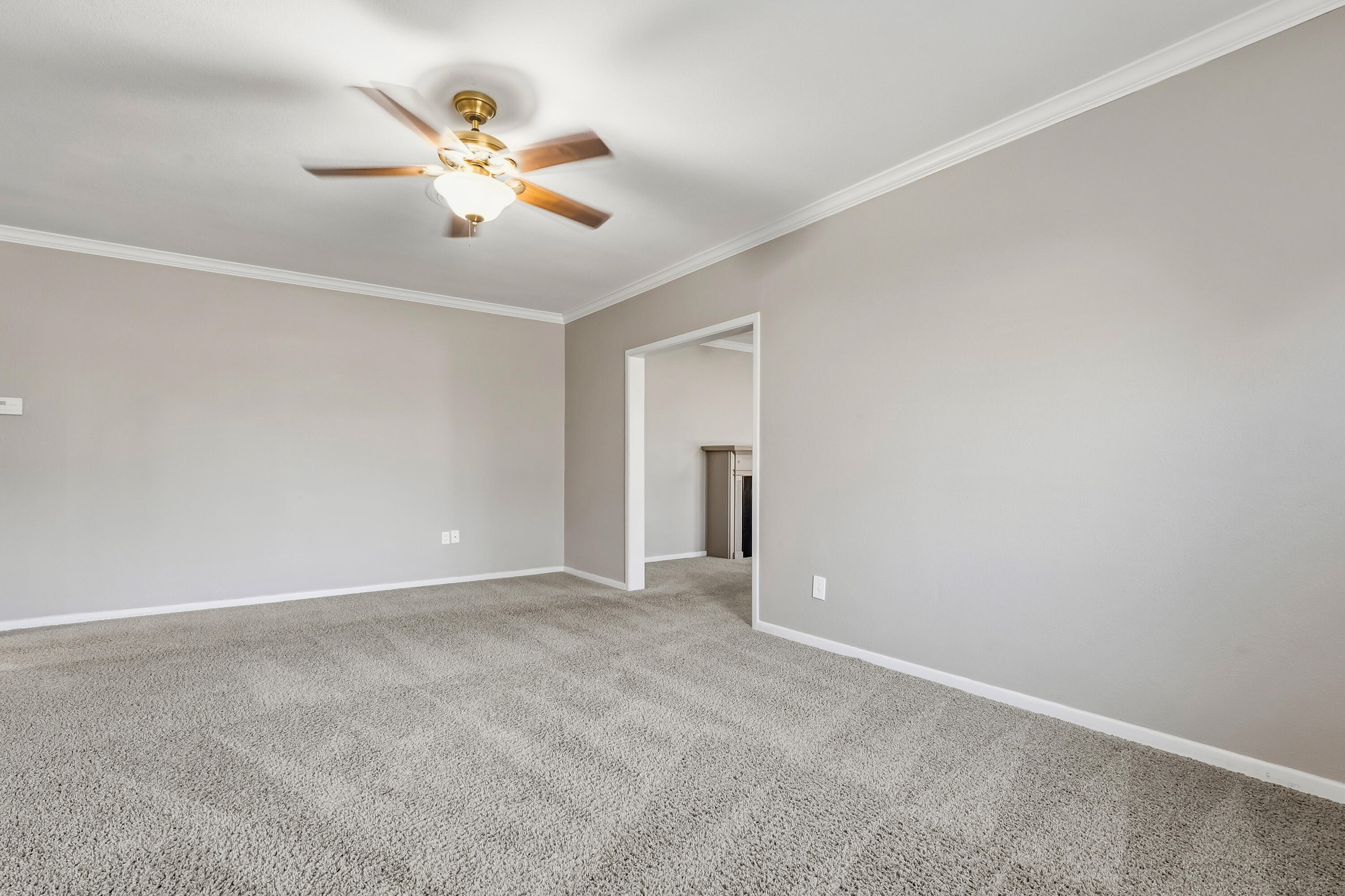 4831 10th Street Lubbock, TX 79416 - Photo 5 of 25 a view of an empty room with window and chandelier fan