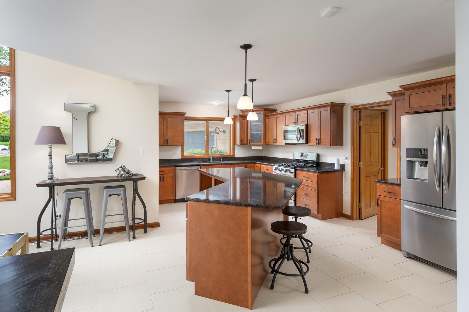 732 South Raven Road Shorewood, IL 60404 - Photo 11 of 48 a kitchen with stainless steel appliances granite countertop a refrigerator a stove a sink a dining table and chairs with wooden floor