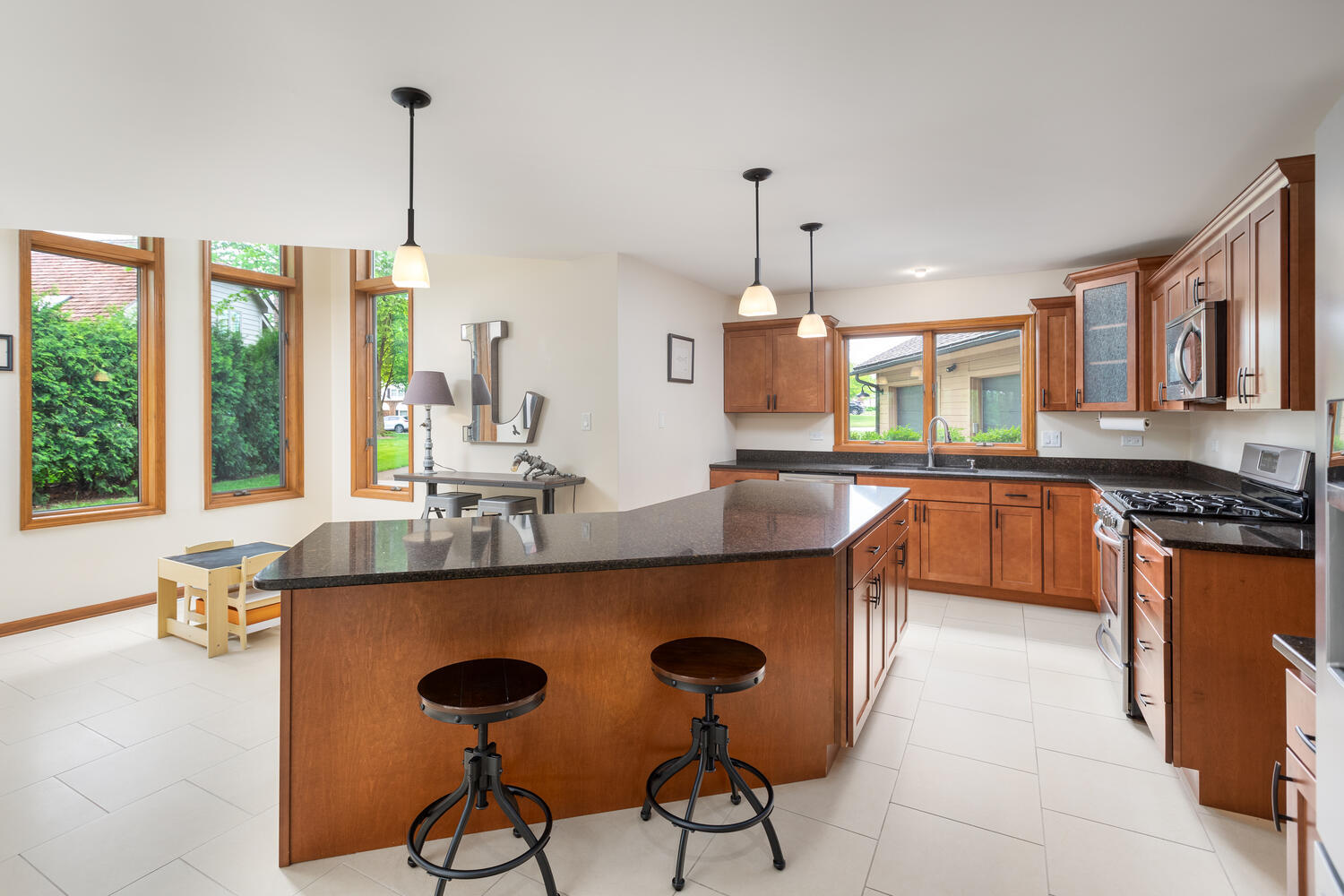 732 South Raven Road Shorewood, IL 60404 - Photo 13 of 48 a kitchen with stainless steel appliances granite countertop a sink a stove and a wooden floors