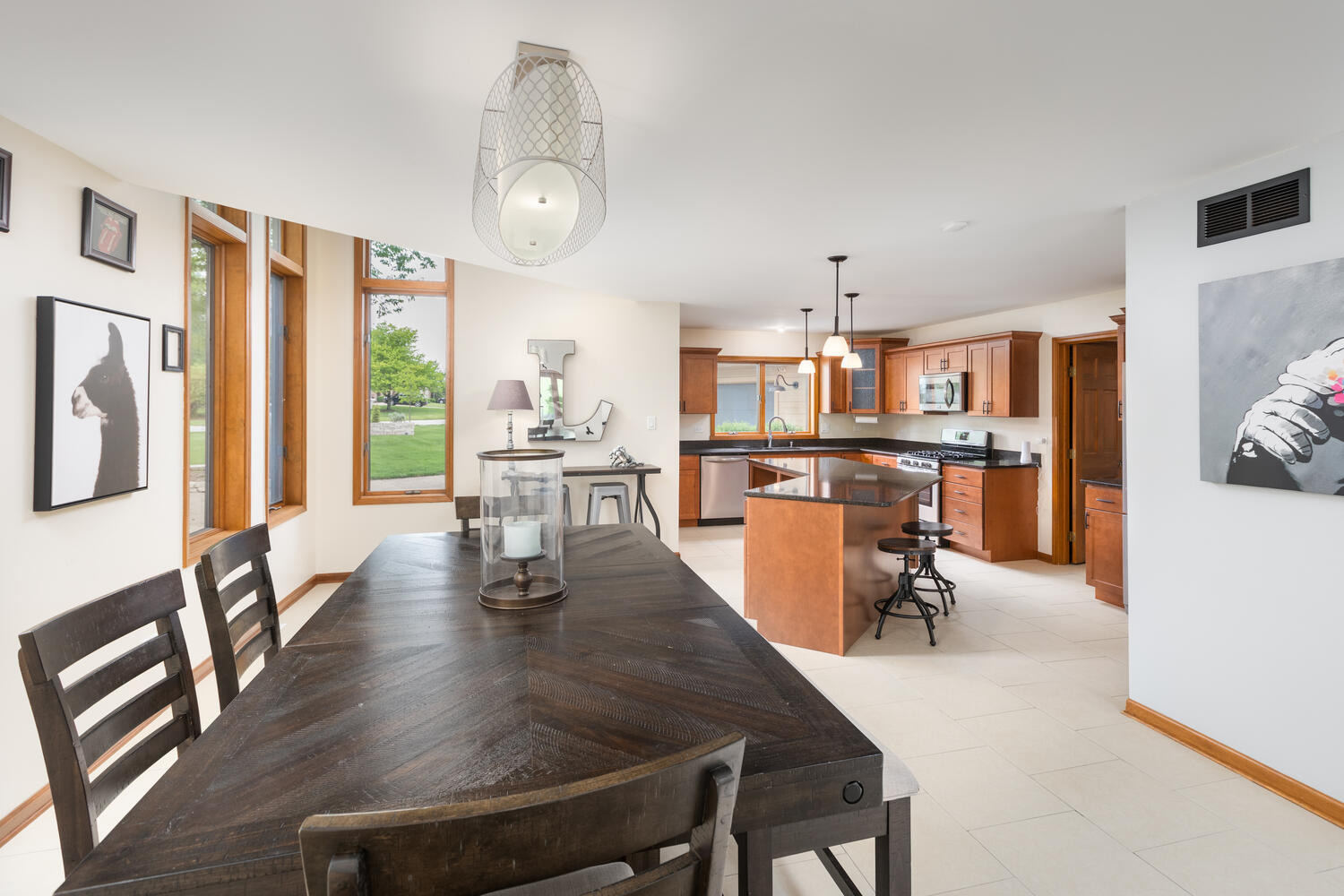 732 South Raven Road Shorewood, IL 60404 - Photo 8 of 48 a dining room with stainless steel appliances kitchen island granite countertop a table chairs and a dining table view