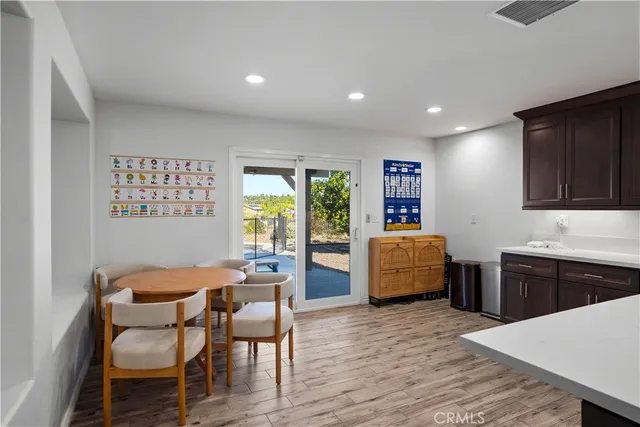a dining room with furniture and wooden floor