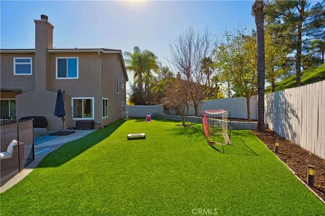 a view of a backyard with table and chairs