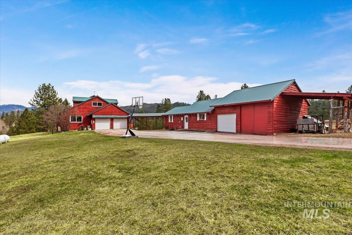 6 East Beck Road Garden Valley, ID 83622 - Photo 32 of 44 View of grassy yard featuring driveway and an attached garage