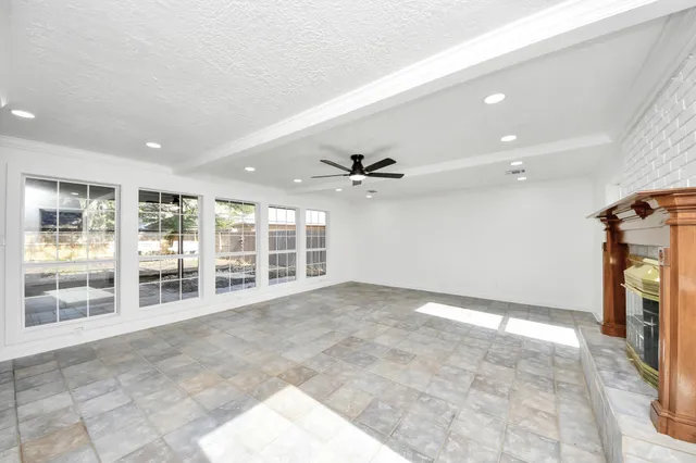 an aerial view of residential houses with outdoor space and trees