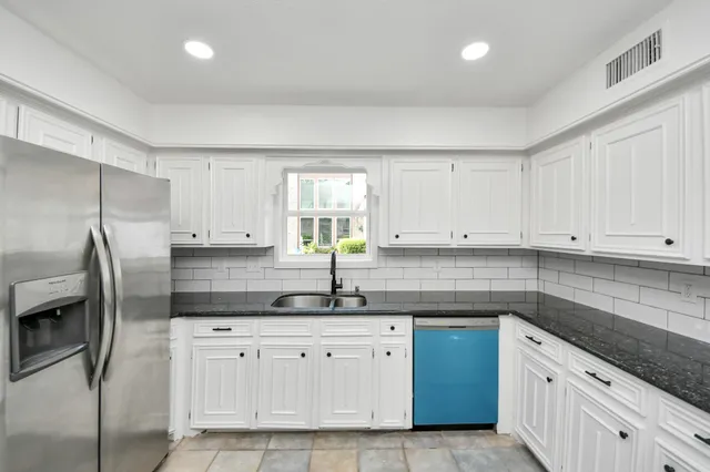 a view of an empty room with a fireplace and a window