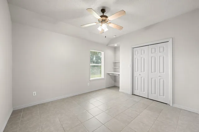 a bathroom with a granite countertop sink a toilet and shower