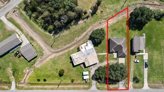 a front view of house with yard and garage