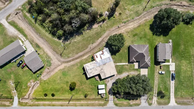 an aerial view of a house with swimming pool and outdoor seating