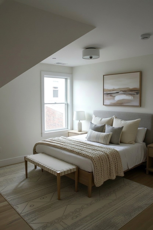 71 Mozart Street, Unit 3 Boston, MA 02130 - Photo 11 of 26 a spacious bedroom with a bed and a window